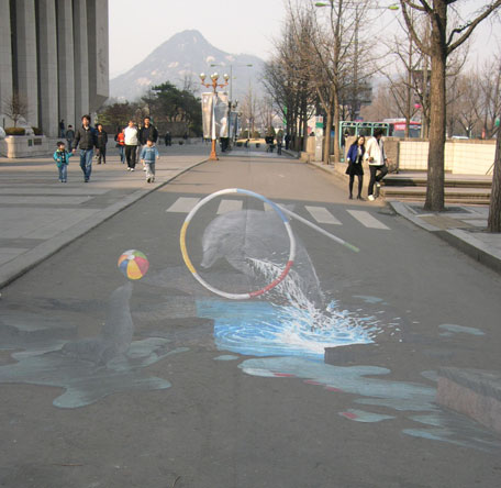 Student 3d street painting of dolphin and seal